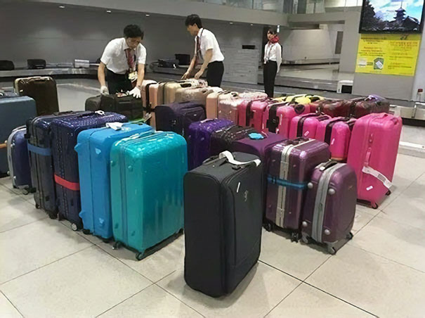 Airport staff sorting luggage by color.