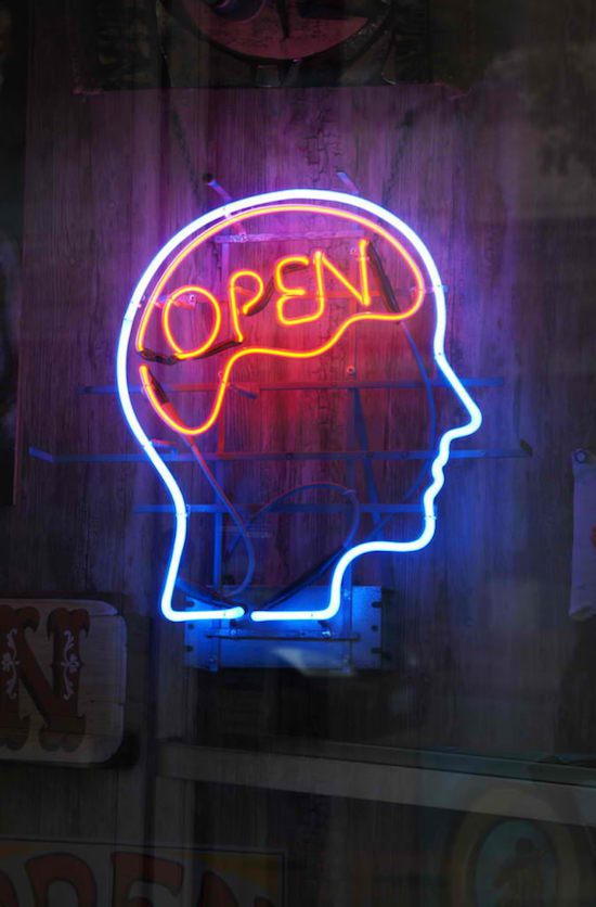Open neon sign on brain