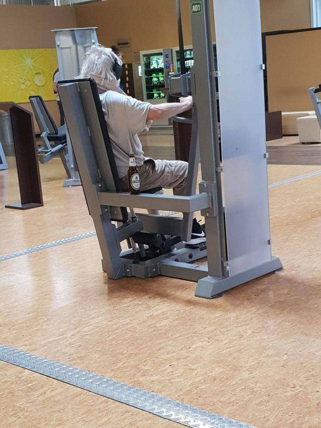 Man having a bear on a workout machine