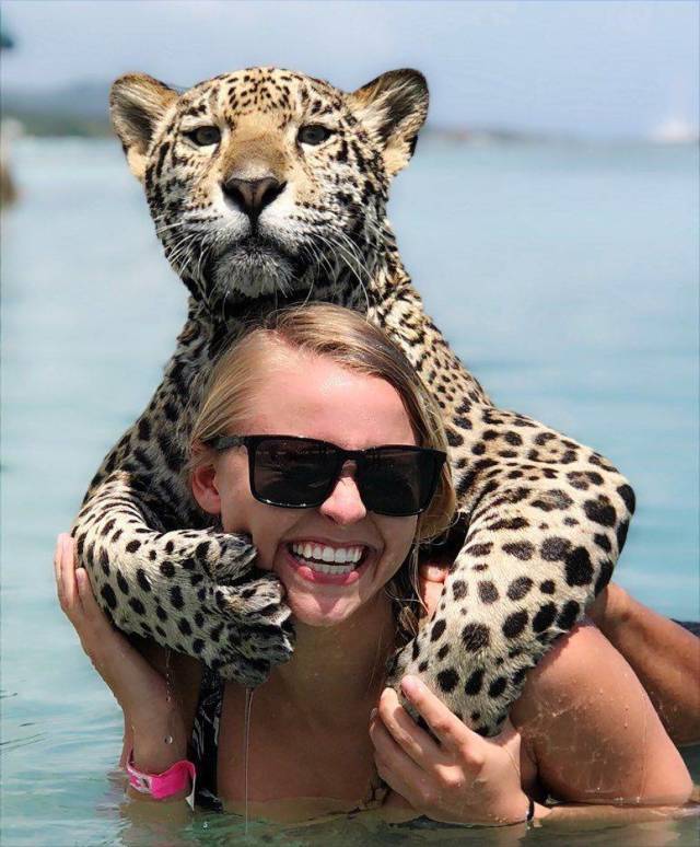 woman posing with Cheetah on her back