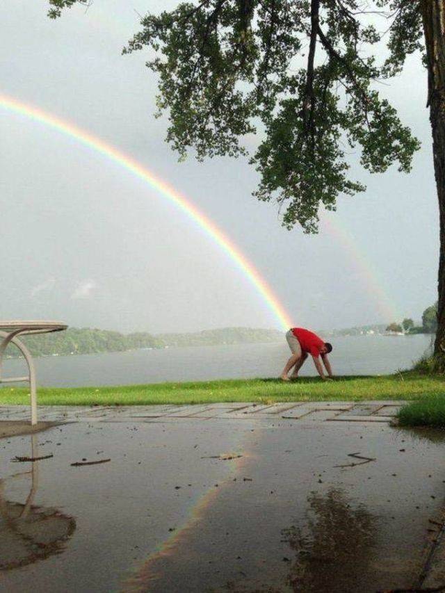 man bending over so that it looks like a rainbow if shooting out of his ass