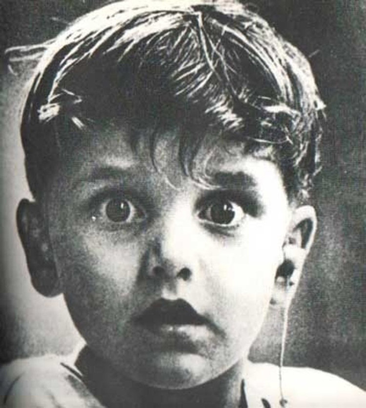 Harold Whittles hears for the first time ever after a doctor places an earpiece in his left ear.