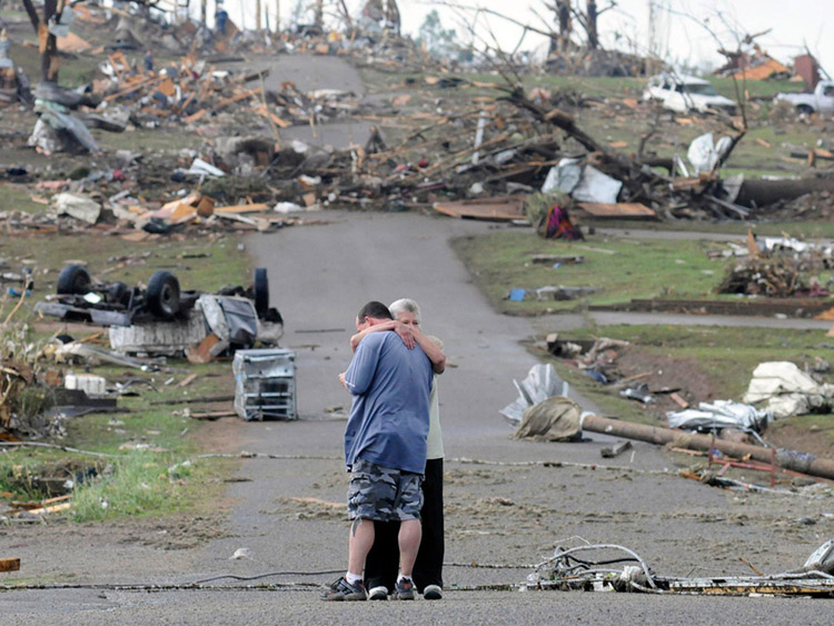 mother comforts her son in Concord, Alabama, near his house which was completely destroyed by a tornado in April of 2011.