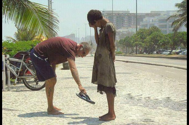 A man giving his shoes to a homeless girl in Rio de Janeiro