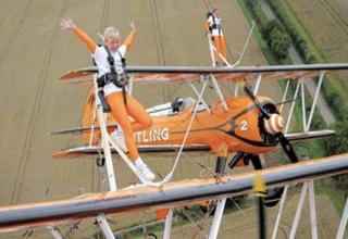 Wing walking in the UK-For almost as long as there have been airplanes there have been people walking on their wings. At least these days you'll probably get strapped in.