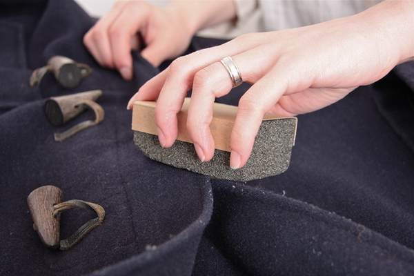 Use a pumice stone to de-fuzz a sweater