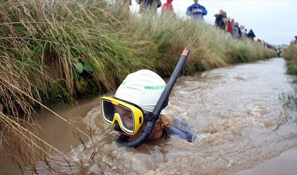 Bog Snorkeling: Competitors race through a murky bog, but they aren't allowed to use their hands. It's flippers only.