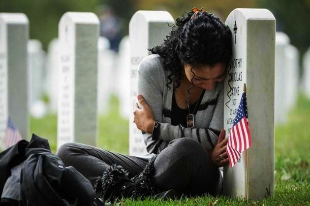 woman crying on soldier's grave