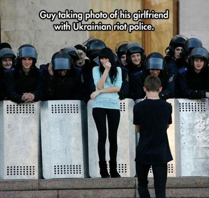 wtf riot guy - Guy taking photo of his girlfriend with Ukrainian riot police.