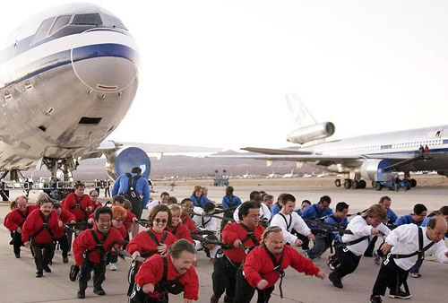 little people pulling plane