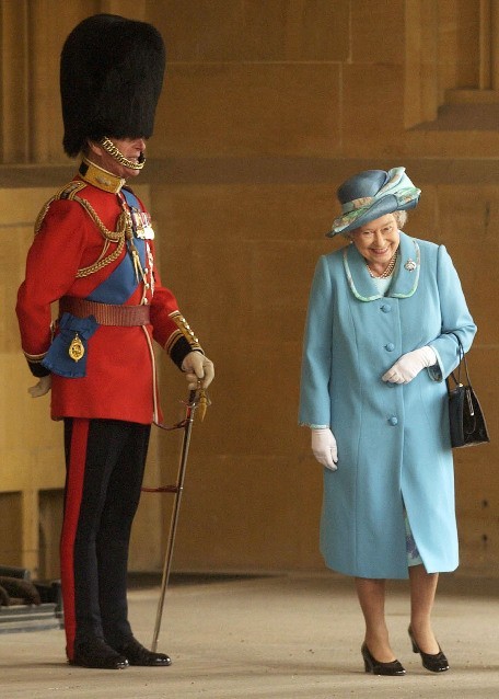 The Queen laughing at her husbands uniform