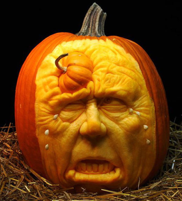 Creative Jack o Lantern carved pumpkin - Twisted looking face with a mini-pumpkin growing out of it