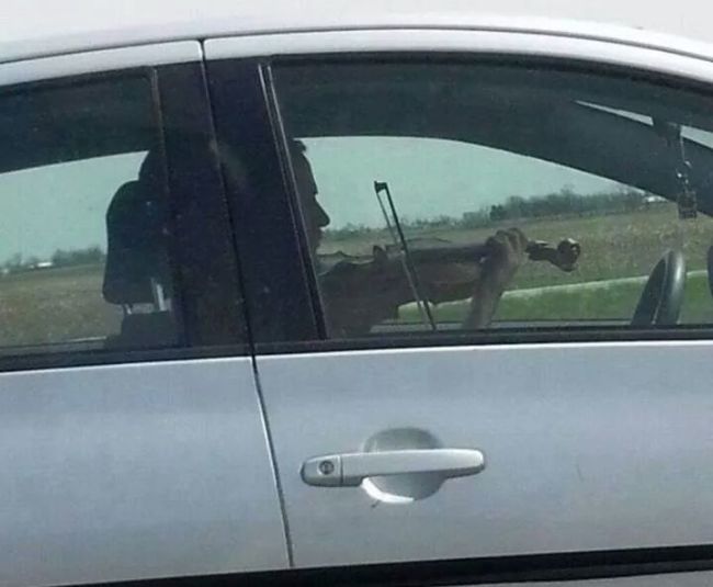 guy playing violin in car
