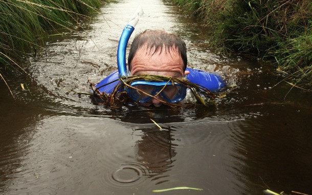Bog snorkeling-Started in Wales in 1976, bog snorkeling is a sporting event that consists of competitors completing two consecutive lengths of a water filled trench cut through a peat bog, in the shortest time possible. Competitors must wear snorkels and flippers, and complete the course without using conventional swimming strokes, relying on flipper power alone.