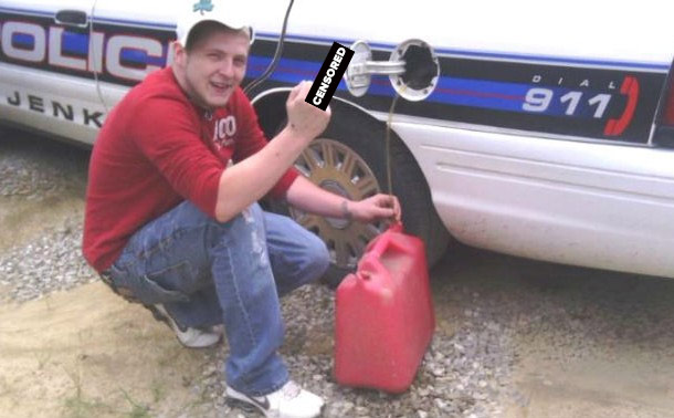 The Genius Who Stole Gas from a Police Car and Posted it on Facebook-In 2012 a young boy from Jenkins, Kentucky, named Michael Baker was probably bored so he decided to get his small town in the national headlines. What did he do, you ask? After he siphoned gas from a local police car, he posed next to it with a smile while also proudly giving the finger for the camera and then posted the photo on Facebook. The photo went viral, with thousands of views, but a couple of days later the police were knocking on the door of his home where they arrested him for his blatant idiocy.