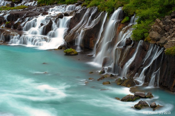 The waterfalls pour into the Hvt River from ledges of less porous rock in the lava. Hvt means "white river" in Icelandic language.