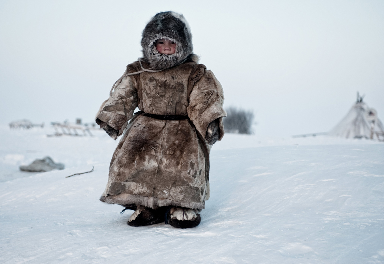 A young Nenet boy in Siberia plays in -30 degrees.