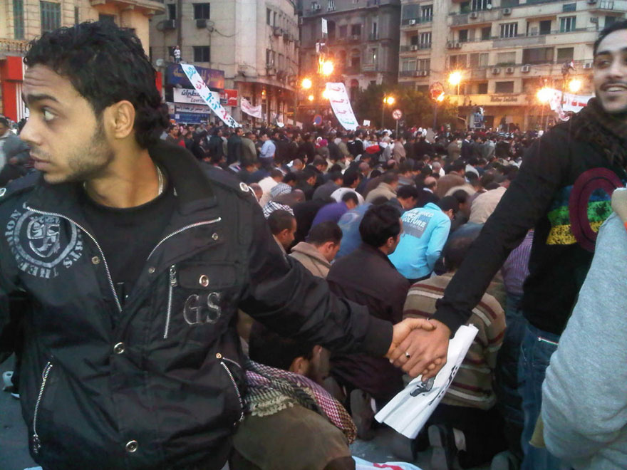 Christians protecting Muslims with a human shield during a prayer, Cairo, Egypt  2011