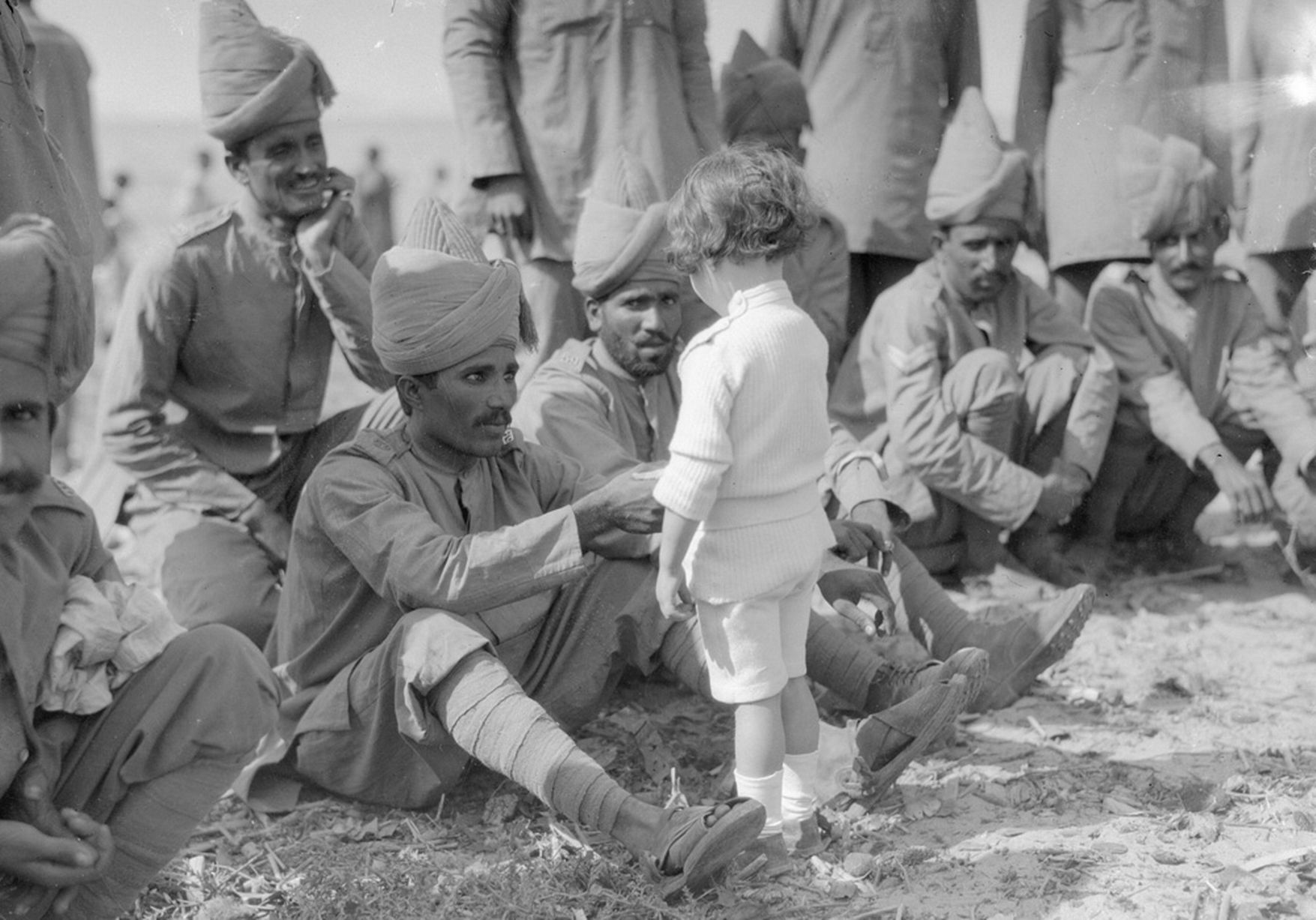 A French boy introduces himself to Indian soldiers who had just arrived in France to fight alongside French and British forces, Marseilles, 30th September. 1914