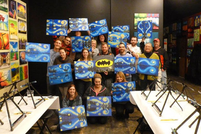 group painting only one person holds batman painting