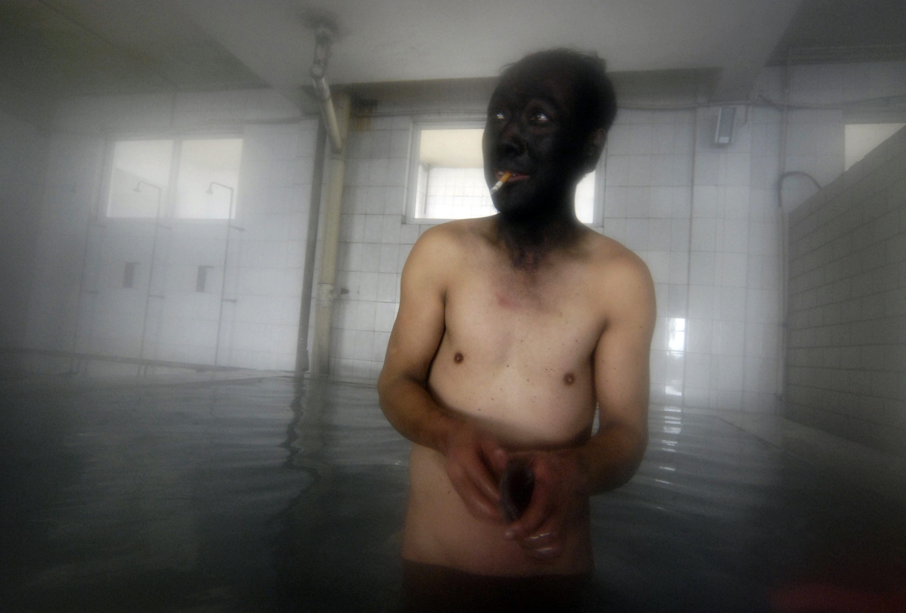 A coal miner takes a bath after his shift at a mine in Changzhi, China