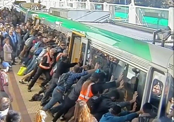 Passengers lifting a train to free a mans leg-Among all the sad and tragic stories of 2014, there are also a few that might restore your faith in humanity. One of them took place on August in a railway station in Perth, Australia, where a mans leg got trapped between the train and the platform. All the passengers jointly lifted the train in order to free the mans leg.