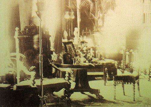 This photo was taken at the Combermere Abbey library in Cheshire, England in 1891 by Sybell Corbet. The ghost is believed to be Lord Combermere, who was killed after being hit by a horse-drawn carriage in 1891.