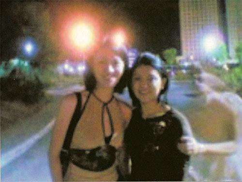 This photo was taken in the Philippines in 2000. It appears that a ghost is grabbing the arm of the girl on the right side of the photo.