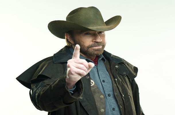 Chuck Norris in a duster and a cowboy hat