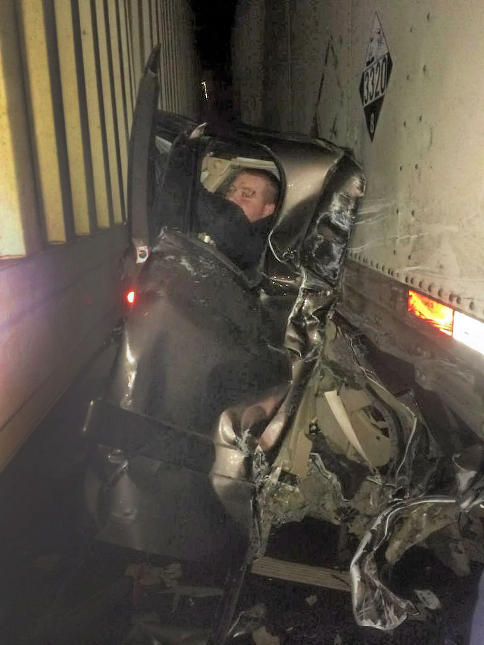 Unreal pic of a pick-up sandwiched between two semi-trucks; driver miraculously survived with no serious injuries-“Kaleb Whitby, 27, who miraculously escaped with minor injuries, was sandwiched in his pickup truck between two trailers in the Baker City crash. The photographer, Sergi Karplyuk, helped the man out of his car. Whitby’s injuries only required two band-aids and ice. Photo by Sergi Karplyuk”