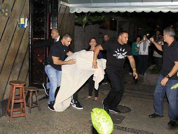 JB leaving a Brothel in RIO under a sheet.