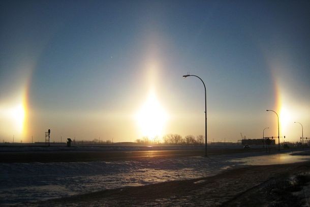 Also known as mock suns or phantom suns, sundogs are an atmospheric phenomenon that consists of a pair of bright spots on either side of the Sun, often co-occurring with a luminous ring. These are created by the refraction of light from plate-shaped ice crystals either in high and cold cirrus clouds or, during very cold weather.