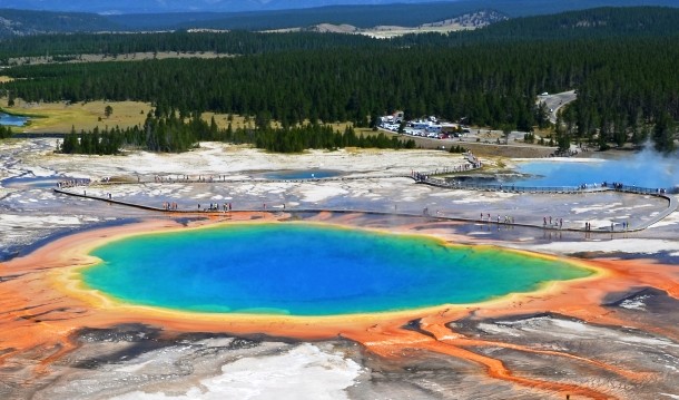 Found in the Yellowstone National Park, the Grand Prismatic Spring is the largest hot spring in the United States, and the third largest in the world. Notable for its vivid colors caused by pigmented bacteria living around the edges of the mineral-rich water, the spring is approximately 250 by 300 feet (80 by 90 m) in size and 160 feet (50 meters) deep. It discharges an estimated 560 gallons (2,100 liters) of 160 °F (70 °C) water per minute.