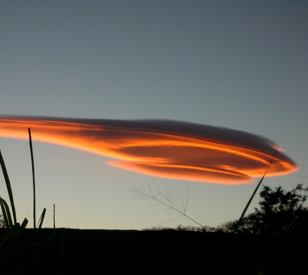 Originating in the troposphere, lenticular clouds rank among the rarest and most unusual types of clouds. As moist air travels up some obstacle (for example a mountain), it collects on the top of it and forms a lens-shaped cloud. Because of their unique shape, lenticular clouds have even been mistaken for UFOs.