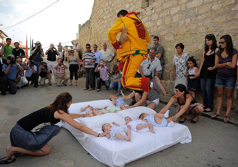 Baby Jumping-When in Spain, jump over babies!  Well, why not? This festival is called El Colacho to locals but internationally it’s referred to as the baby jumping festival. Yes, you read that right. During this festival, men dressed as the devil in red and yellow jumpsuits jump over a row of up to 10 babies