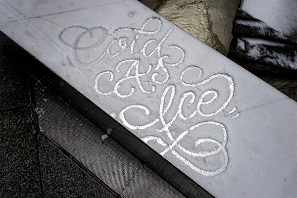 Creating calligraphic art on snow-covered cars