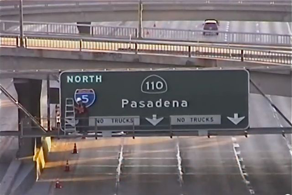 Artist Adds Exit Sign to Los Angeles Freeway...If you live in Los Angeles or at least have watched an episode of The Californians, you know that the LA freeway system can be incredibly confusing.

One especially irksome area was near downtown Los Angeles, where a crucial piece of signage was missing, causing many people, including artist Richard Ankrom, to get lost. But unlike other drivers who perhaps cursed and shrugged it off, Ankrom decided he would fix it. On August 5, 2001, after carefully creating an exact replica of a Caltrans sign, Ankrom snuck onto the overhead signage and hung it up. The new marker was so convincing (and necessary) when Caltrans found out about the project called Guerrilla Public Service they left it up.