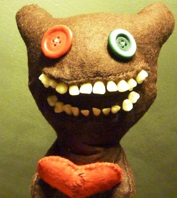 Despite the supposedly cute heart and button eyes, the human teeth make this toy a bizarrely creepy thing.