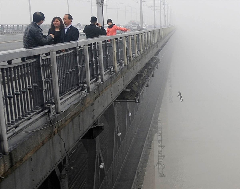 A young man jumps from the Yangtze River Bridge in Wuhan, China, into the river following another person who committed suicide minutes earlier.