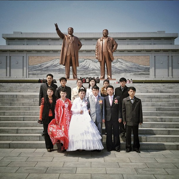 Wedding portrait in front of the two Kim’s statues