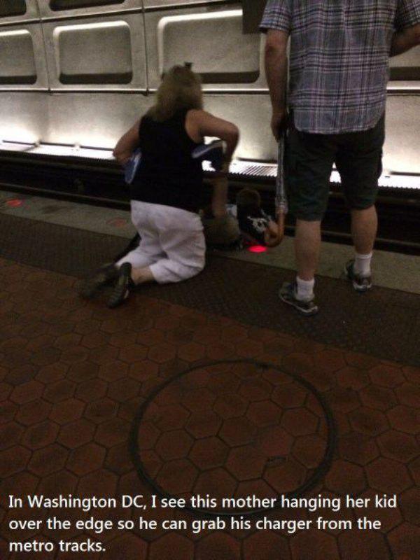 bad parental skills - In Washington Dc, I see this mother hanging her kid over the edge so he can grab his charger from the metro tracks.