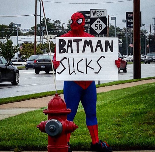 spider man holding a sign - Cina Batman Sucks