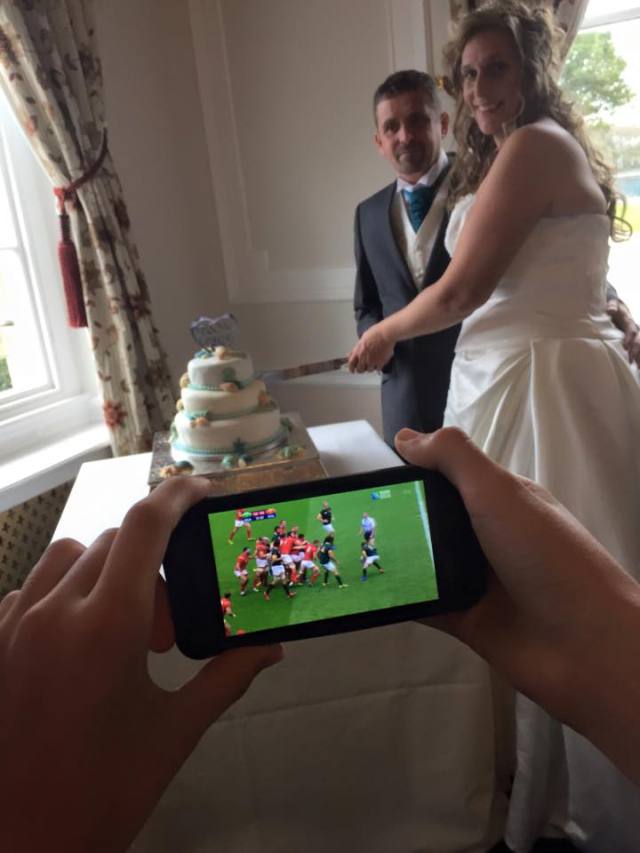 watching football on phone at wedding