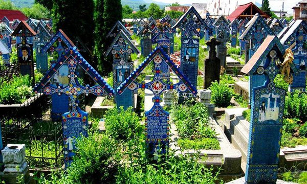 Romania : The Săpânţa Merry Cemetery The Merry Cemetery in the region of Maramures has burial chambers built in wood, painted in bright colors...