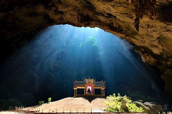 Thailand : Phraya Nakhon Cave A Buddhist temple built in the middle of the cave Phraya Nakhon in Thailand is illuminated by the light of heaven...