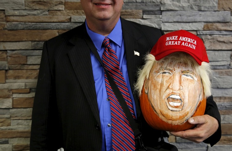 A man holds a Donald Trump pumpkin at an event in   Springfield, Illinois. Republican candidates had their fourth debate this week
