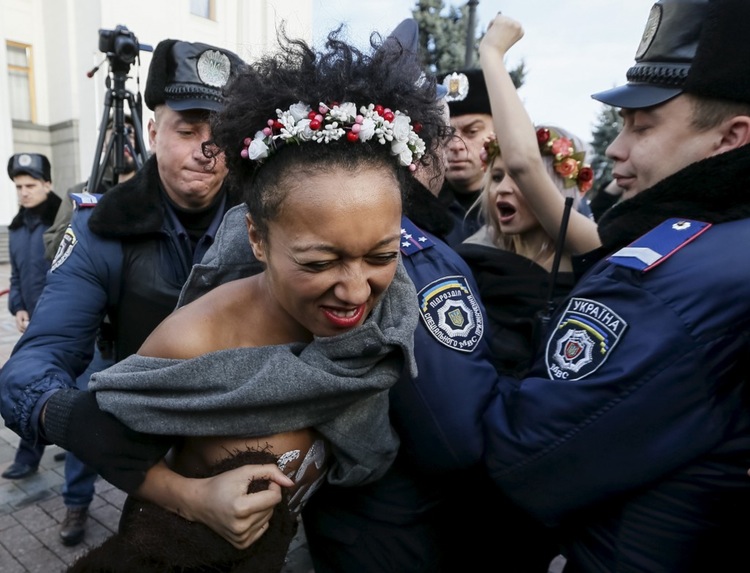 Ukrainian police detain activists of women's rights group Femen as they protest against homophobia in Kiev, Ukraine.