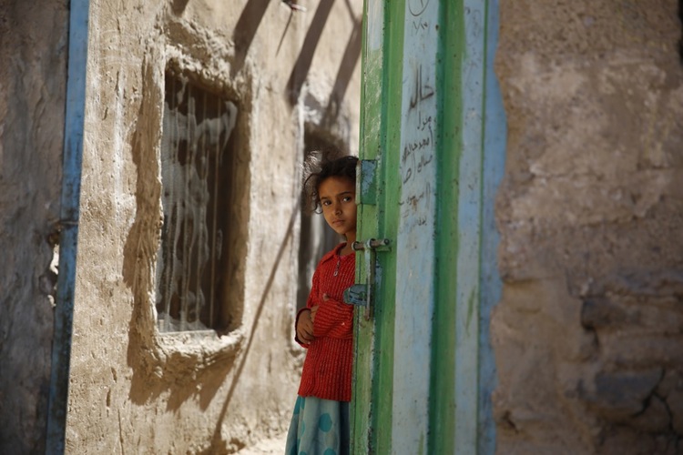 A girl stands in a doorway as she awaits her polio vaccination in Sanaa, Yemen. A three-day national campaign immunized 5 million children this week despite conflict in the country.