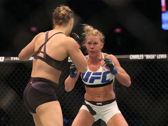 Round 1. Rousey comes in swinging wildly with punches. Holm circles from the outside and connnects with a hard combination includes a straight punch to the jaw. Rousey clinches a minute and 20 seconds in. Holm brushes off the clinch and lands a few hard punches.
