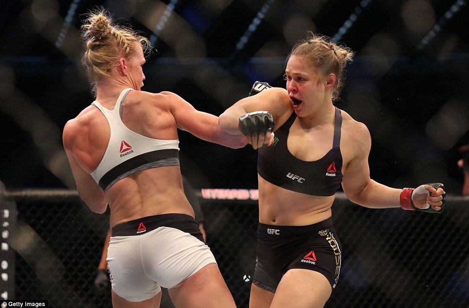 Rousey is bleeding from the nose. Rousey gets a clinch and takes Holm down, but she can't get the armbar. Holm backs off and lands a big punch as they return to the feet. Rousey continues to look to close distance with Holm landing shots as she moves in. Holm is pounding Rousey with shots. Rousey hurts Holm with a hook. Holm is forced to clinch and takes Rousey down. Holm then backs off and stands up. Rousey charges in wildly in desperation. They clinch and exchange knees to the body. 10-9 Holm.
